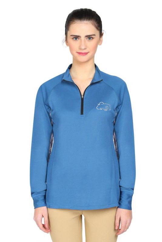 Woman in blue Tuffrider equestrian shirt with zipper and logo.