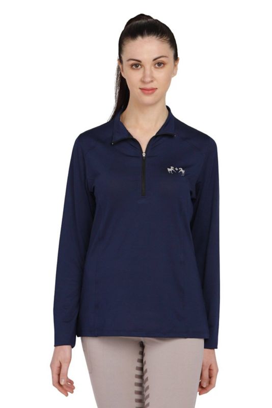 Woman in navy blue Tuffrider equestrian pullover standing against white background.