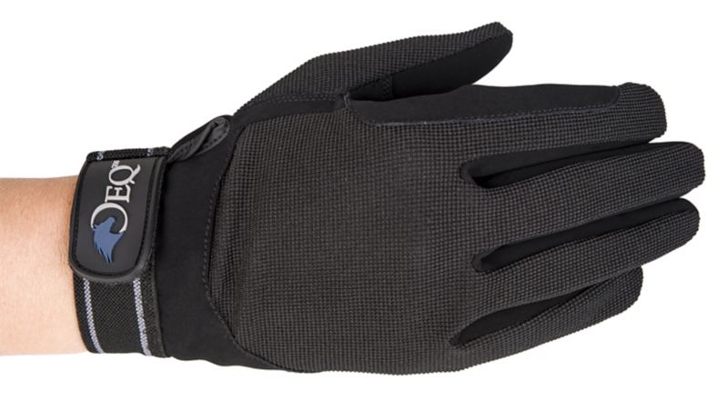 Black textured sports glove with adjustable strap on human hand.