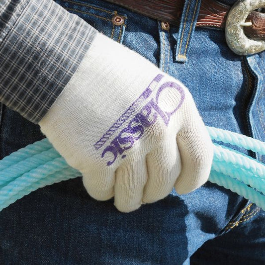 Person wearing gloves holding a blue rope with denim background.