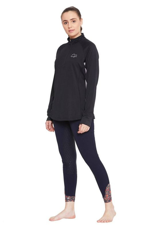 Woman wearing Tuffrider logo black turtleneck and navy equestrian tights.