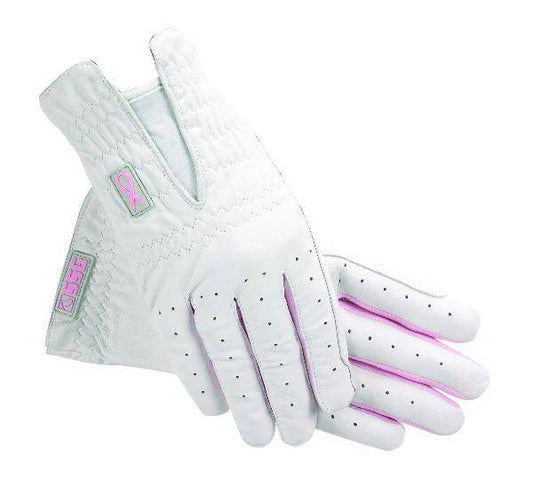 White golf gloves with pink accents and grip dots isolated on white.