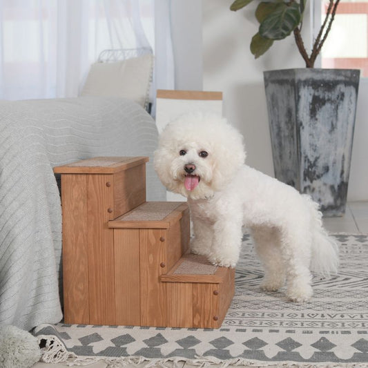 White fluffy dog standing on Merry Products wooden pet stairs.
